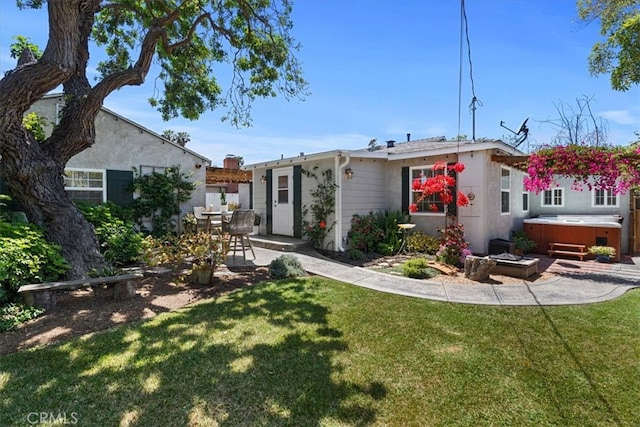 8212 Reading Ave, Los Angeles, CA 90045 - rear view of house with a hot tub, a patio area, and a lawn