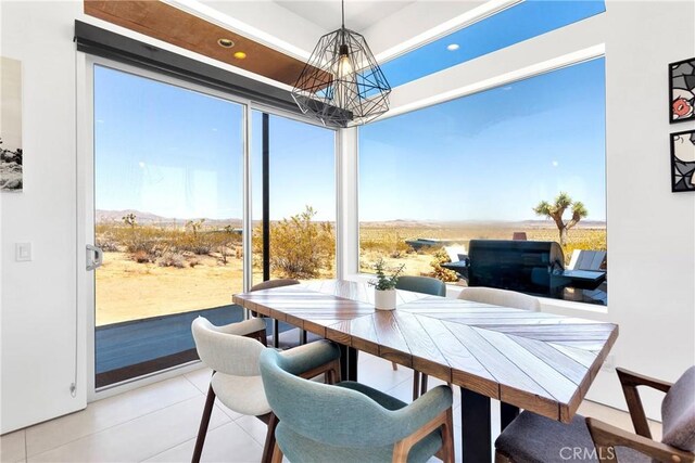 dining room with an inviting chandelier, recessed lighting, plenty of natural light, and light tile patterned floors