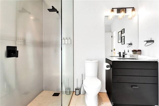 full bath featuring vanity, tile patterned floors, a stall shower, and toilet