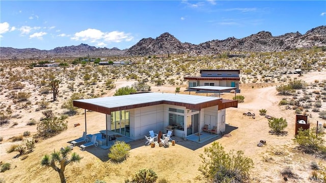 64172 Hollinger Rd, Joshua Tree, CA 92252 - rear view of property with view of desert, a mountain view, a patio area, and a view of rural / pastoral area
