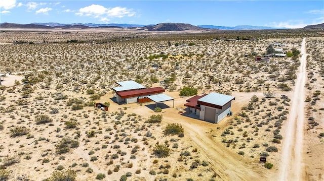 drone / aerial view with a rural view, a mountain view, and a desert view
