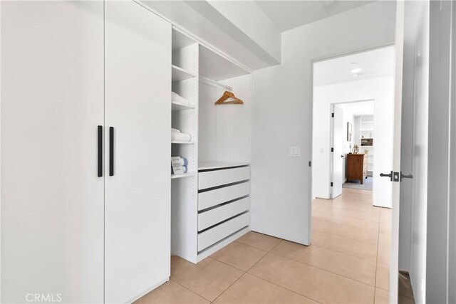 spacious closet with light tile patterned flooring