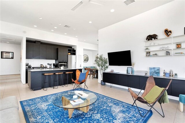 living area featuring visible vents, recessed lighting, and light tile patterned floors