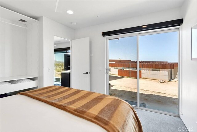 bedroom featuring multiple windows, carpet flooring, recessed lighting, and access to exterior