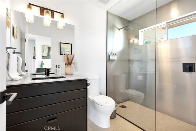 bathroom featuring toilet, walk in shower, tile patterned flooring, and vanity