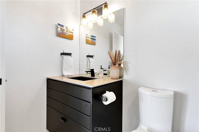 half bath with vanity and toilet