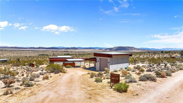 exterior space with a mountain view, view of desert, and a rural view