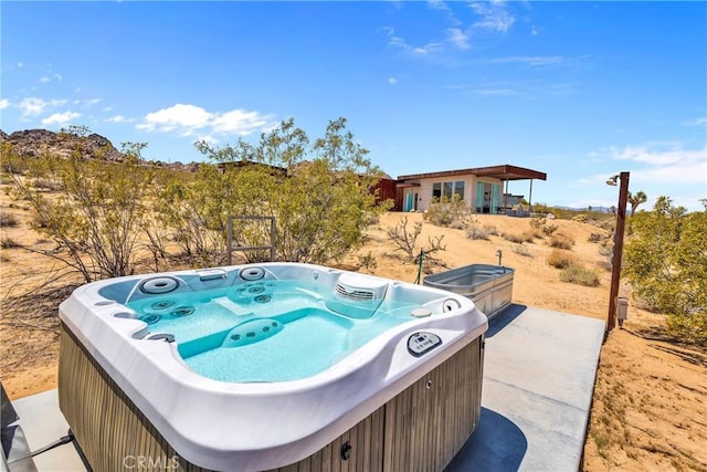 exterior space featuring a hot tub