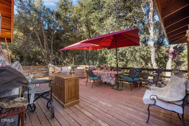 wooden terrace with an outdoor living space