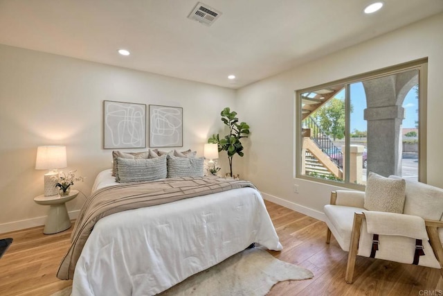 bedroom with light wood-style floors, baseboards, recessed lighting, and visible vents