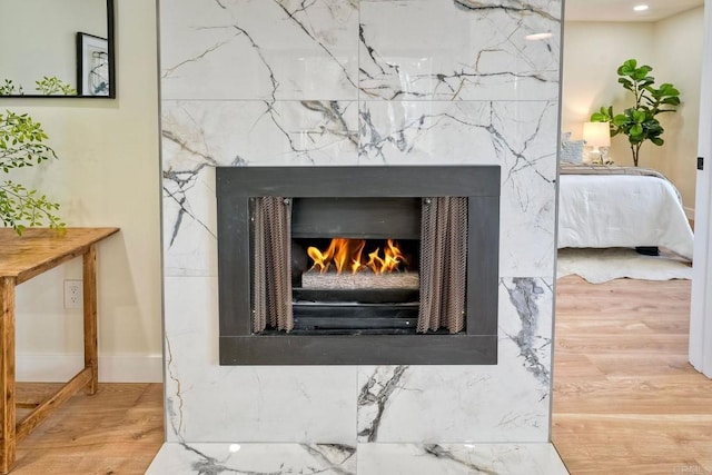 interior details with wood finished floors and a high end fireplace
