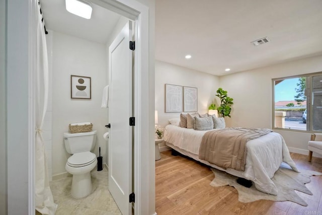 bedroom featuring baseboards, recessed lighting, wood finished floors, and visible vents