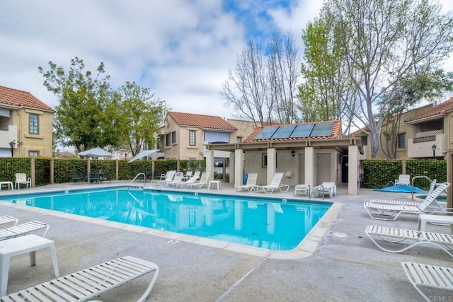 pool with fence and a patio