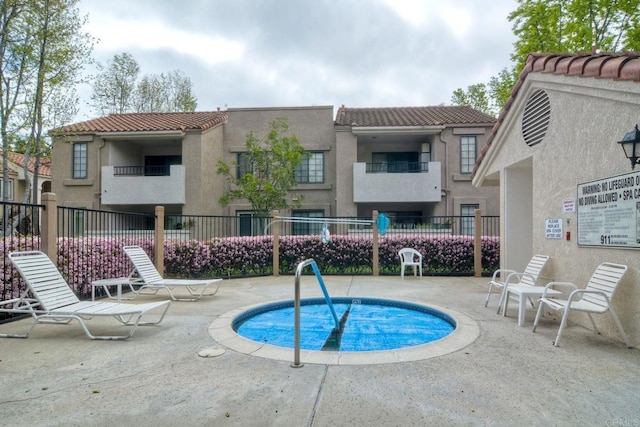 view of pool with a patio area and fence
