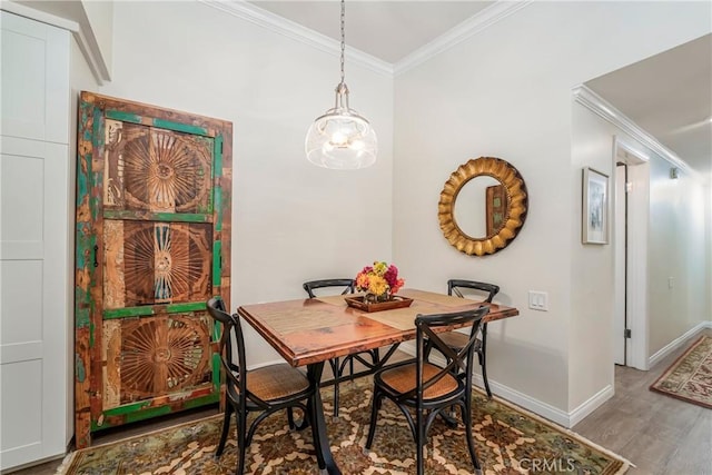 76 Calle Aragon Unit Q, Laguna Woods, CA 92637 - dining space featuring ornamental molding, baseboards, wood finished floors, and a chandelier
