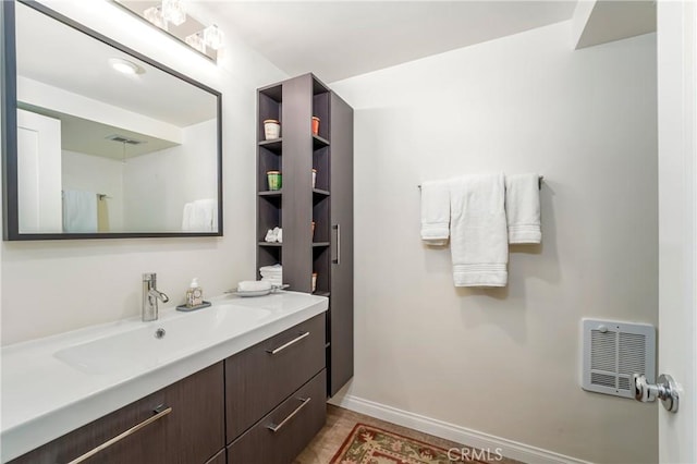 76 Calle Aragon Unit Q, Laguna Woods, CA 92637 - bathroom with vanity, baseboards, and heating unit
