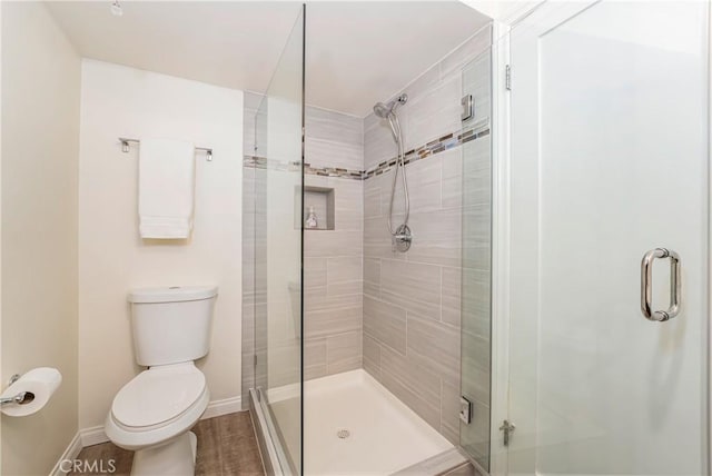 76 Calle Aragon Unit Q, Laguna Woods, CA 92637 - full bathroom with a stall shower, toilet, and baseboards