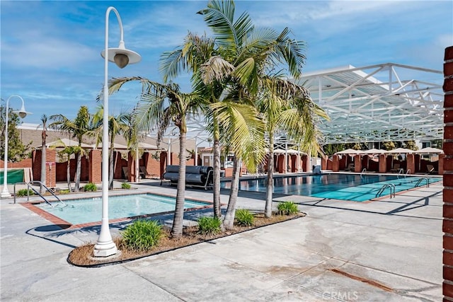 76 Calle Aragon Unit Q, Laguna Woods, CA 92637 - community pool featuring a patio