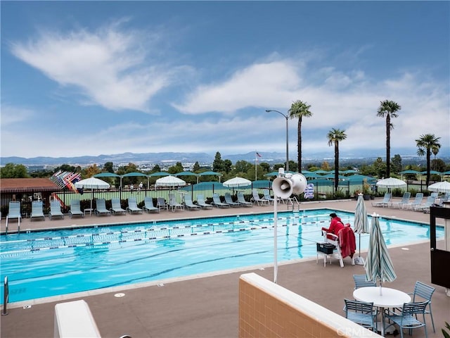 76 Calle Aragon Unit Q, Laguna Woods, CA 92637 - community pool with a patio and a mountain view