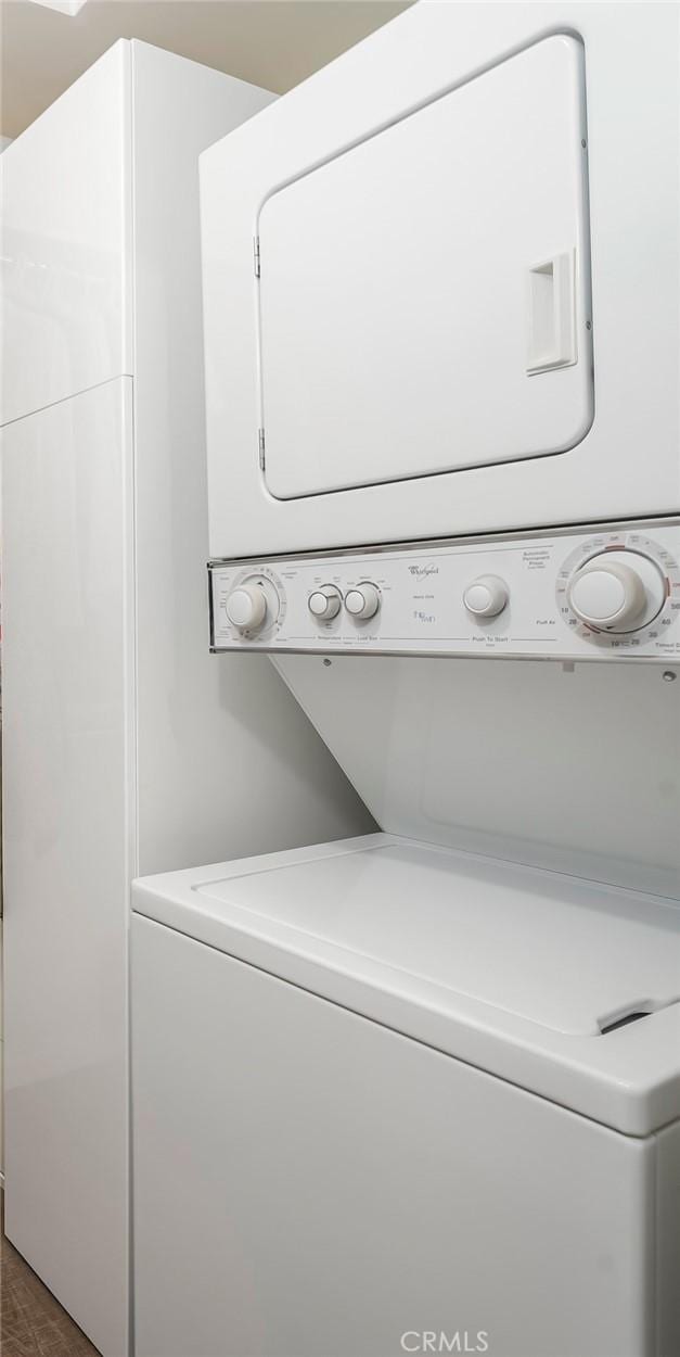 76 Calle Aragon Unit Q, Laguna Woods, CA 92637 - washroom with stacked washer and clothes dryer