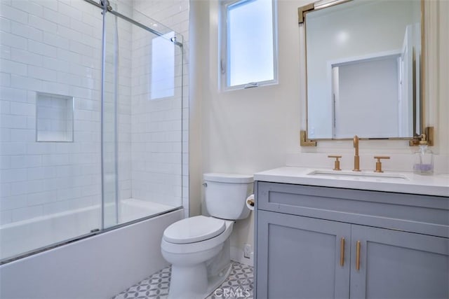 bathroom with toilet, bath / shower combo with glass door, and vanity