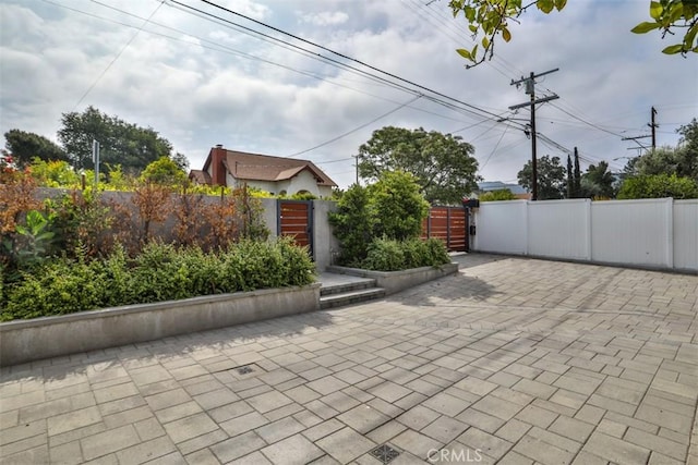 view of patio with a gate and fence