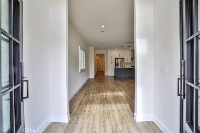 interior space featuring baseboards, recessed lighting, and light wood-style flooring