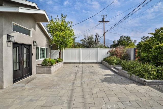 view of patio featuring a fenced backyard and french doors