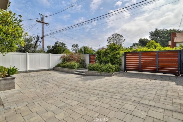 view of patio / terrace with fence and a gate
