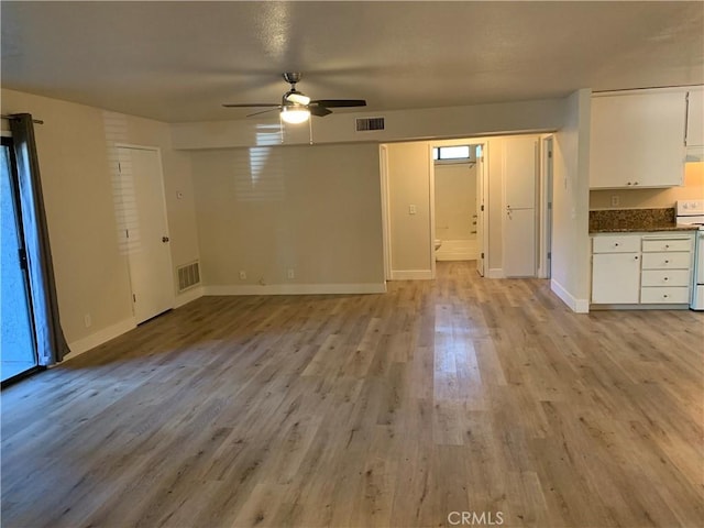 unfurnished living room featuring ceiling fan, visible vents, baseboards, and light wood-style floors