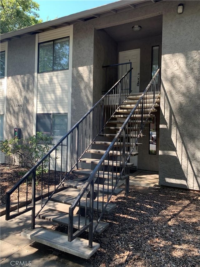 view of exterior entry with stucco siding
