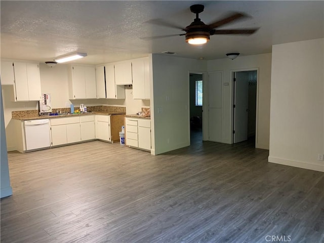 kitchen featuring ceiling fan, dark wood-style flooring, white dishwasher, baseboards, and white cabinets