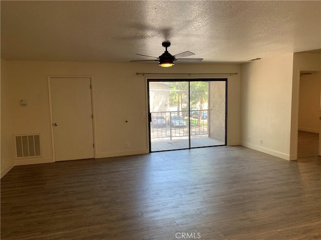 unfurnished room with visible vents, wood finished floors, baseboards, a textured ceiling, and a ceiling fan