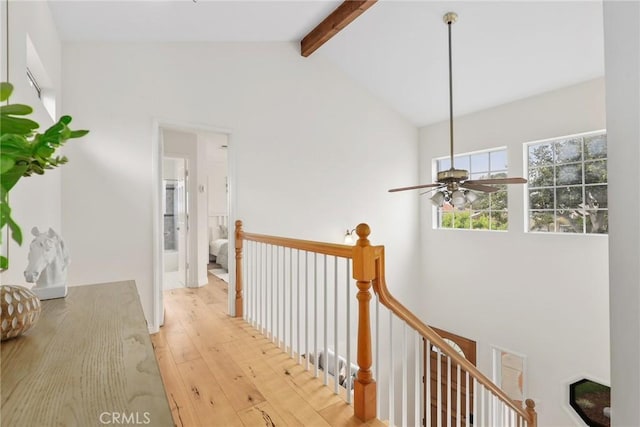 corridor featuring high vaulted ceiling, an upstairs landing, beam ceiling, and light wood finished floors