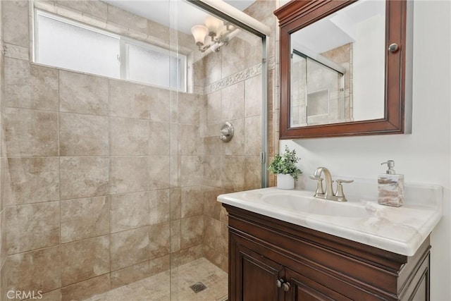 bathroom with a shower stall and vanity