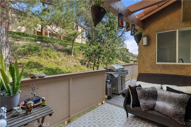 view of patio / terrace with a wooden deck and a grill