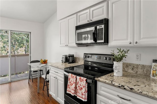 kitchen featuring white cabinets, black electric range oven, and light stone countertops
