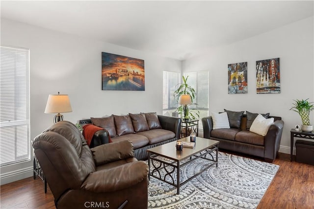living area with baseboards and wood finished floors