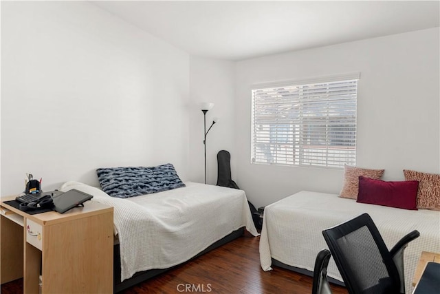 bedroom with dark wood-type flooring