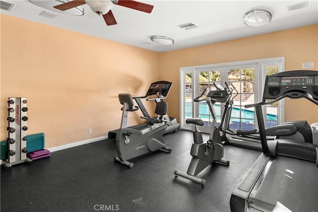 exercise room featuring ceiling fan, visible vents, and baseboards