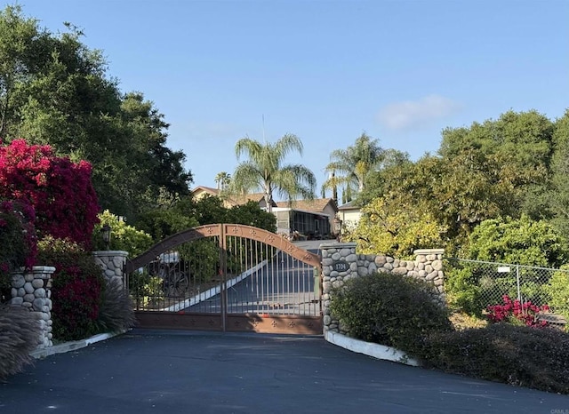 view of gate with fence