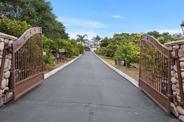 1704 Winterwarm Dr, Fallbrook, CA 92028 - view of street with a gate and a gated entry