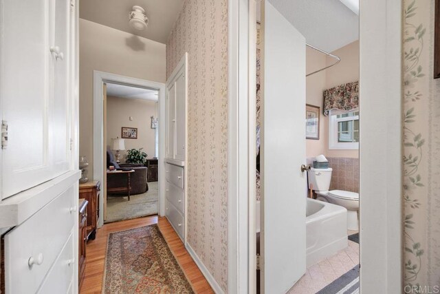 1704 Winterwarm Dr, Fallbrook, CA 92028 - hallway with wallpapered walls and light wood-type flooring