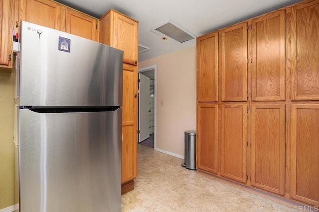 1704 Winterwarm Dr, Fallbrook, CA 92028 - kitchen with freestanding refrigerator, brown cabinets, and light floors