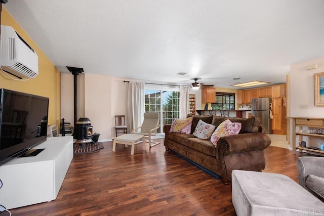 1704 Winterwarm Dr, Fallbrook, CA 92028 - living area featuring a wood stove, a wall mounted air conditioner, wood finished floors, and ceiling fan