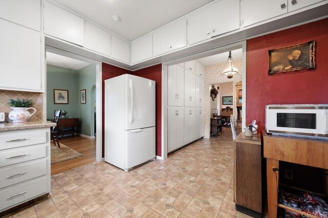 1704 Winterwarm Dr, Fallbrook, CA 92028 - kitchen with white appliances, light countertops, white cabinetry, and decorative backsplash
