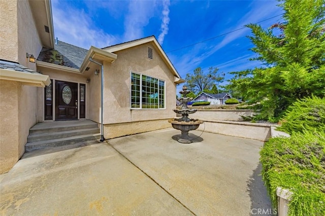 30840 Badger Ct, Coarsegold, CA 93614 - view of exterior entry with stucco siding and a patio area