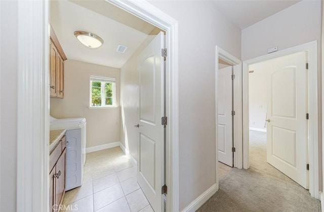 30840 Badger Ct, Coarsegold, CA 93614 - laundry area featuring washing machine and dryer, light tile patterned floors, cabinet space, visible vents, and baseboards