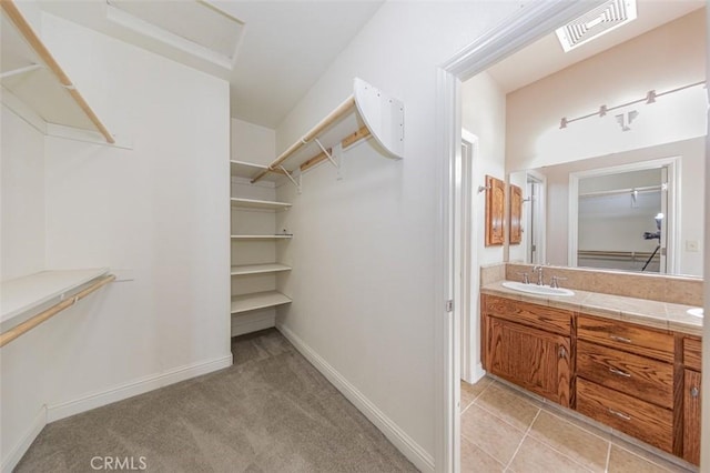 30840 Badger Ct, Coarsegold, CA 93614 - walk in closet with a sink, light colored carpet, and visible vents