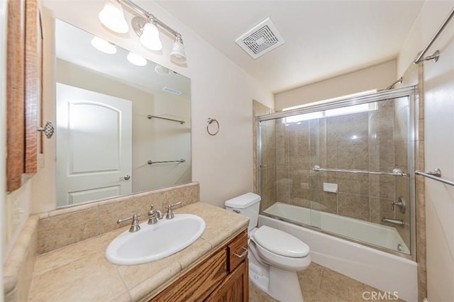 30840 Badger Ct, Coarsegold, CA 93614 - full bath with toilet, enclosed tub / shower combo, visible vents, tile patterned floors, and vanity